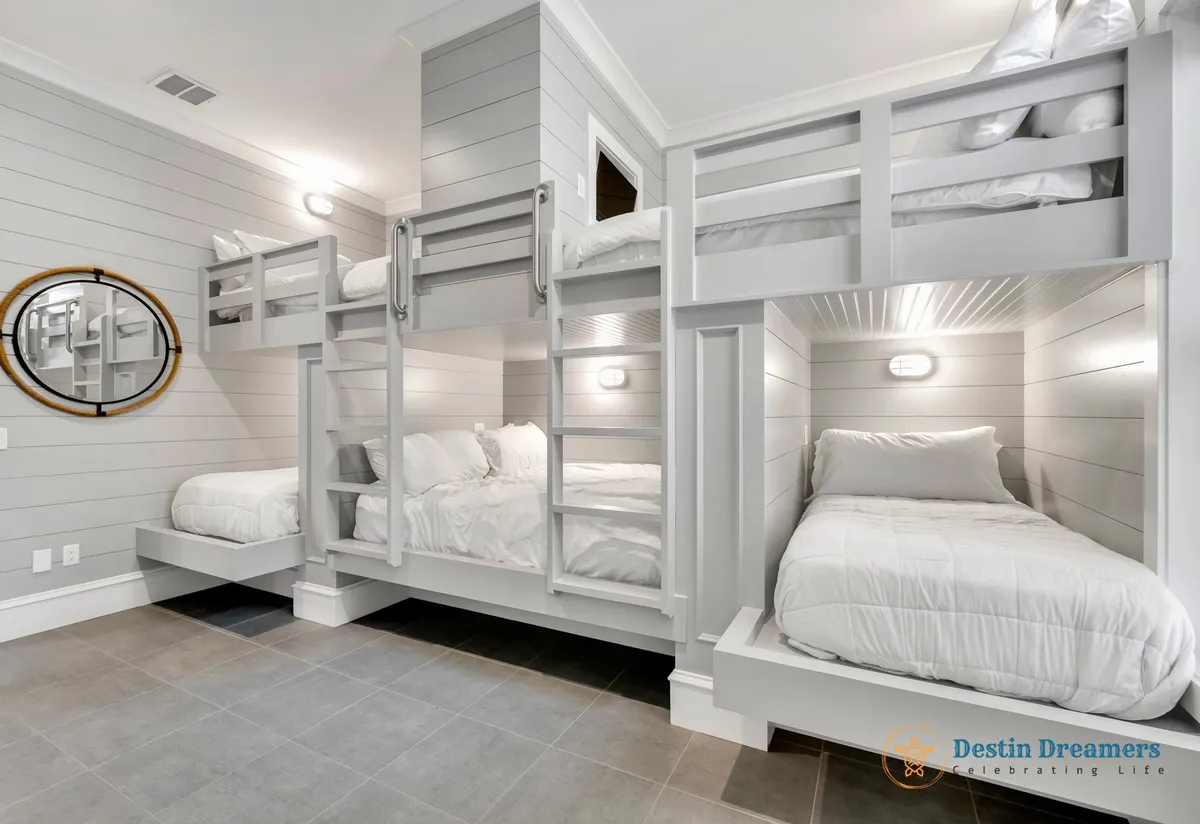 A playful bunk suite with multiple bunk beds, circular mirrors, and stylish light fixtures. The room is designed to be cozy and inviting, ideal for kids or groups of friends enjoying sleepovers and bonding moments.
